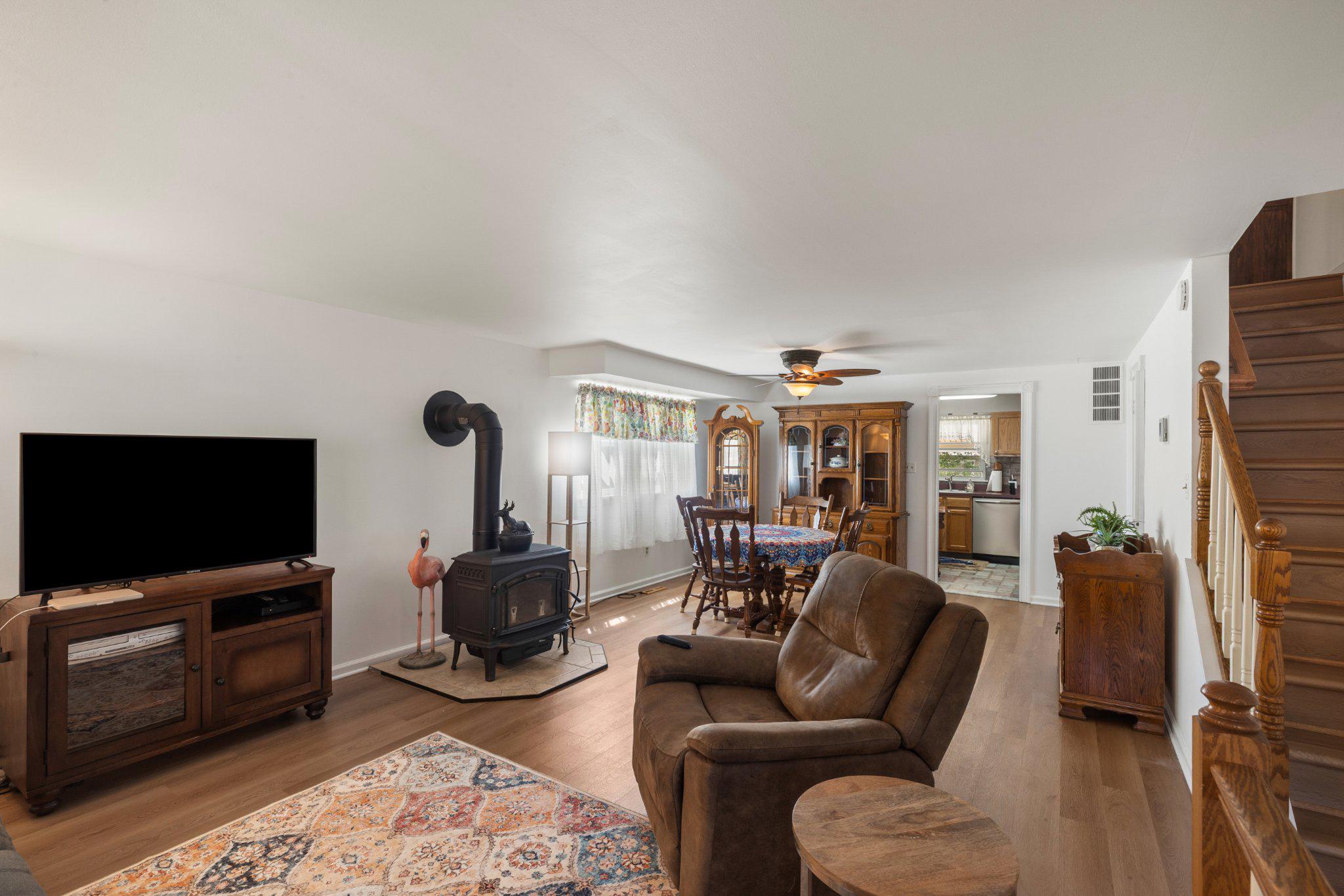 5620 Chelwynd Road Halethorpe, MD 21227 - Photo 4 of 22 a living room with furniture a flat screen tv and a fireplace
