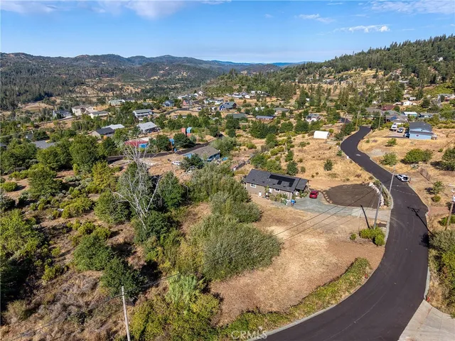 an aerial view of a house with a yard and garden