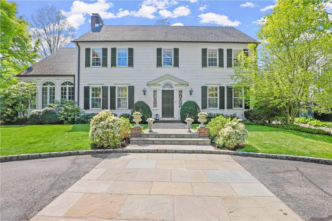 a front view of house with yard and green space