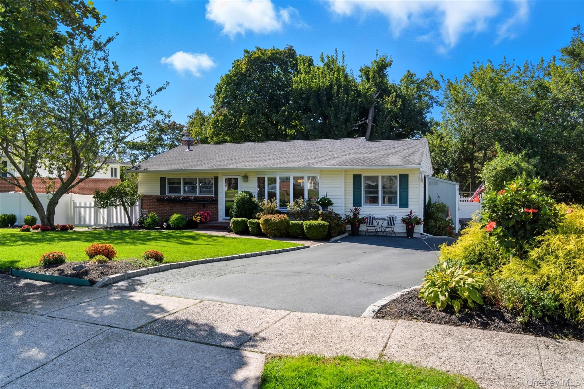 a front view of a house with a yard and outdoor seating