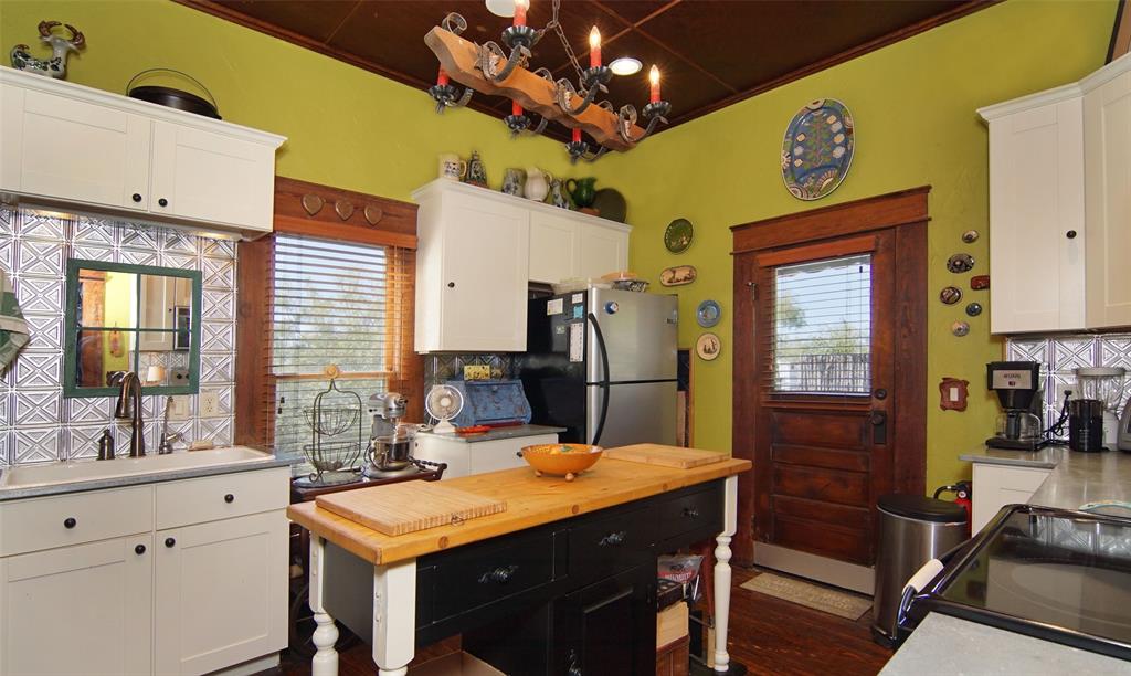 400 Weldons Way Graford, TX 76449 - Photo 14 of 35 a kitchen with a table chairs and a refrigerator