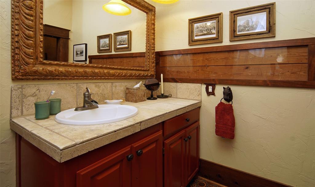 400 Weldons Way Graford, TX 76449 - Photo 21 of 35 a bathroom with a sink and a mirror