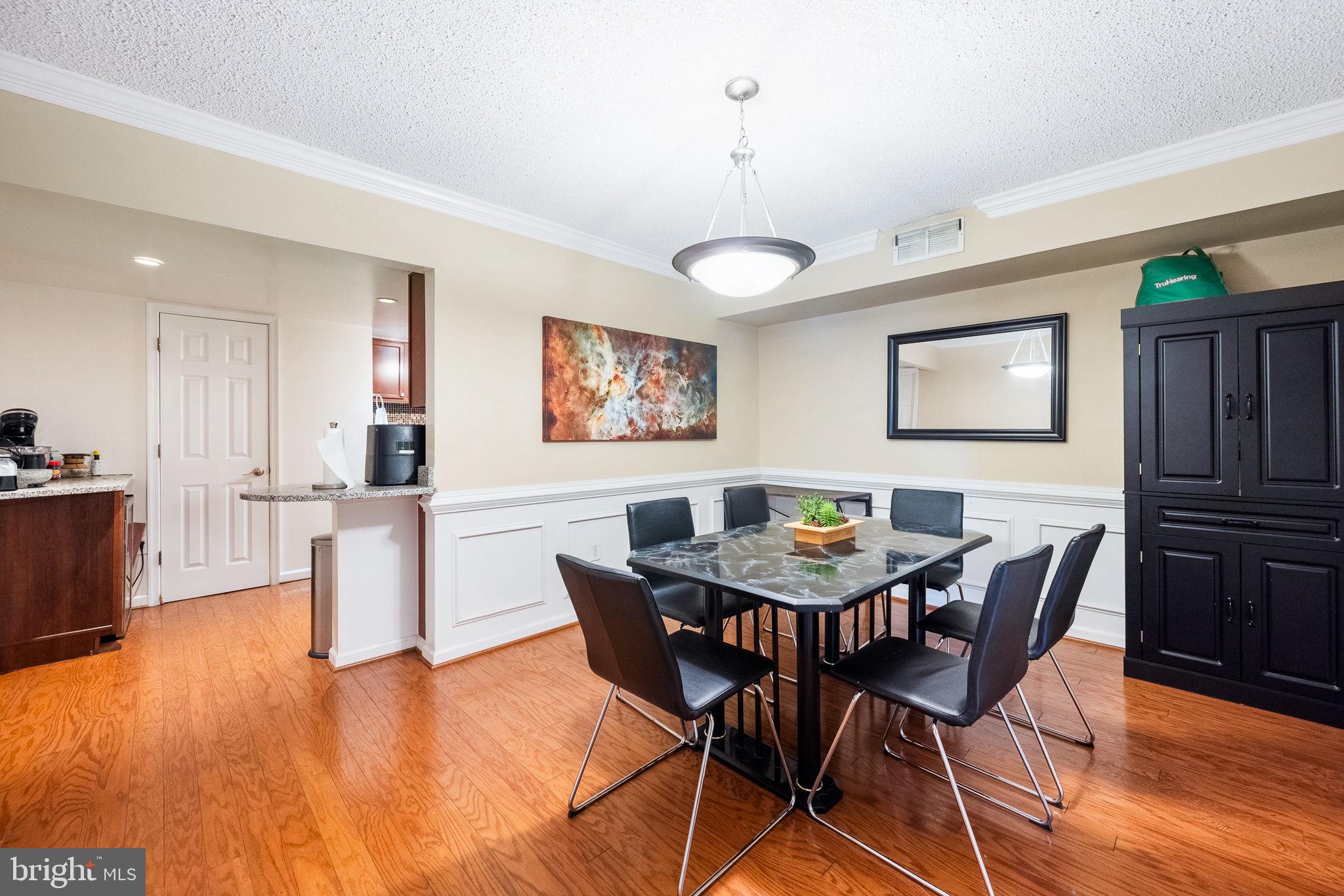 1515 South Arlington Ridge Road, Unit 303 Arlington, VA 22202 - Photo 15 of 34 a view of a dining room with furniture and wooden floor