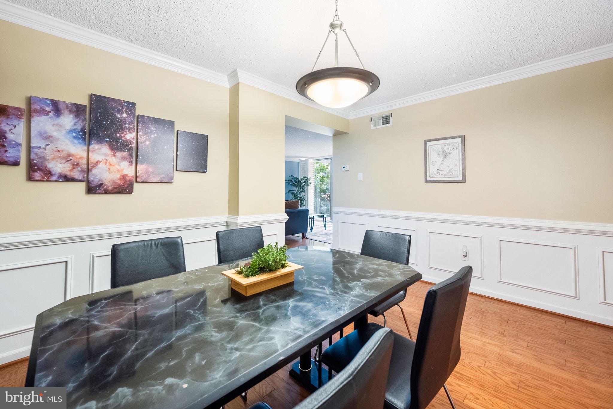 1515 South Arlington Ridge Road, Unit 303 Arlington, VA 22202 - Photo 16 of 34 a view of a dining room with furniture and wooden floor