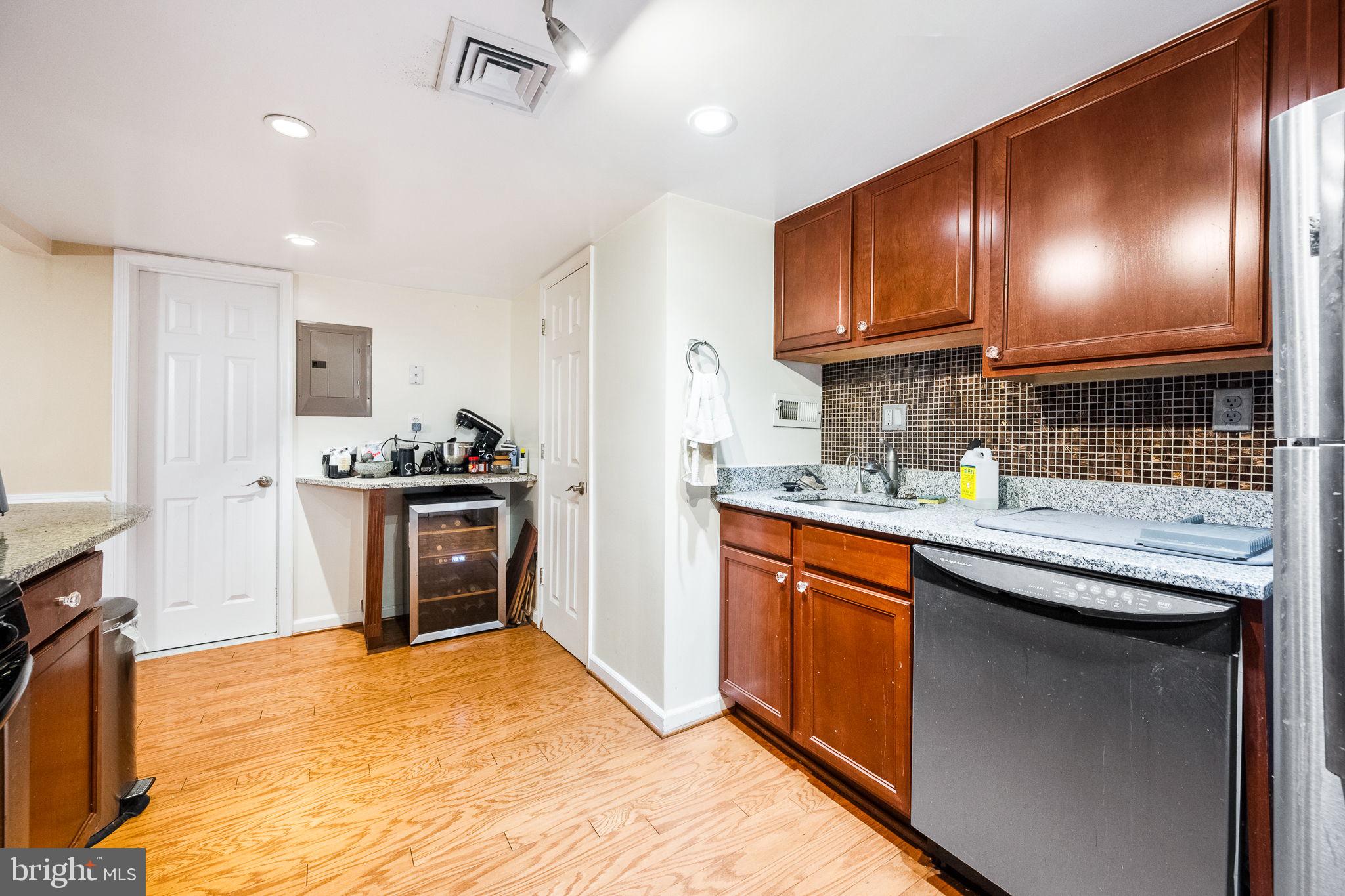1515 South Arlington Ridge Road, Unit 303 Arlington, VA 22202 - Photo 19 of 34 a kitchen with stainless steel appliances granite countertop a sink stove and refrigerator