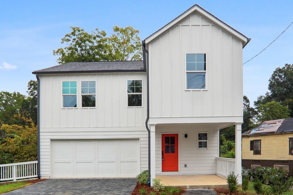 909 Hollywood Road Northwest Atlanta, GA 30318 - Photo 1 of 1 a view of a white house with large windows