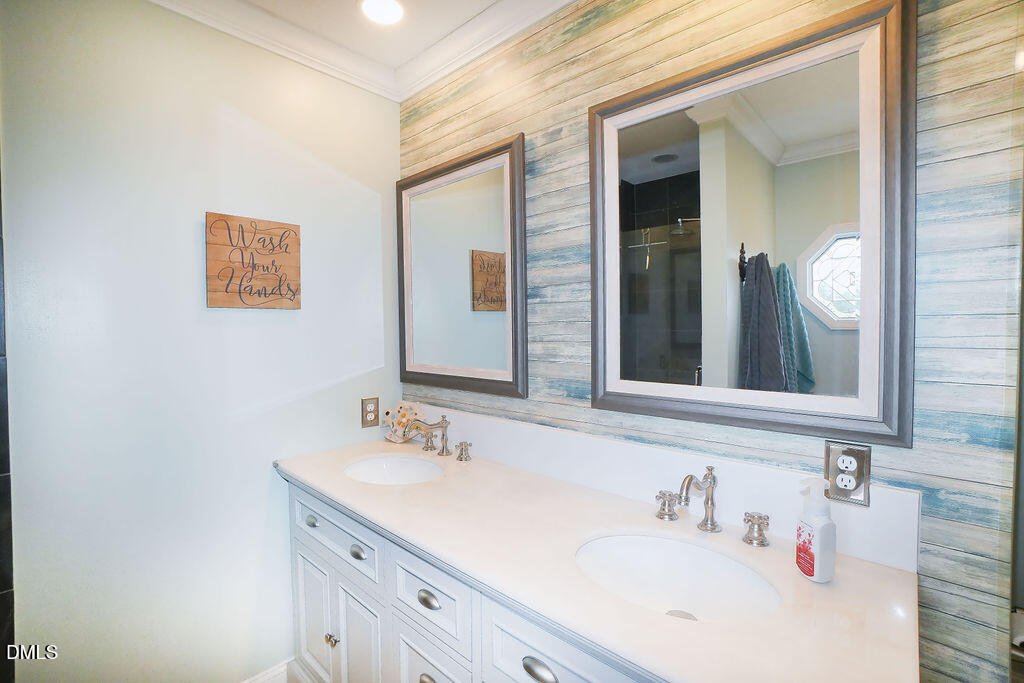 8877 Racine Road Pleasant Garden, NC 27313 - Photo 17 of 45 a bathroom with a sink and a mirror