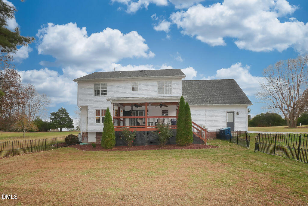 8877 Racine Road Pleasant Garden, NC 27313 - Photo 28 of 45 a view of a house with a yard and plants