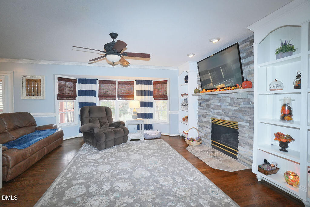 8877 Racine Road Pleasant Garden, NC 27313 - Photo 8 of 45 a living room with furniture fireplace and flat screen tv