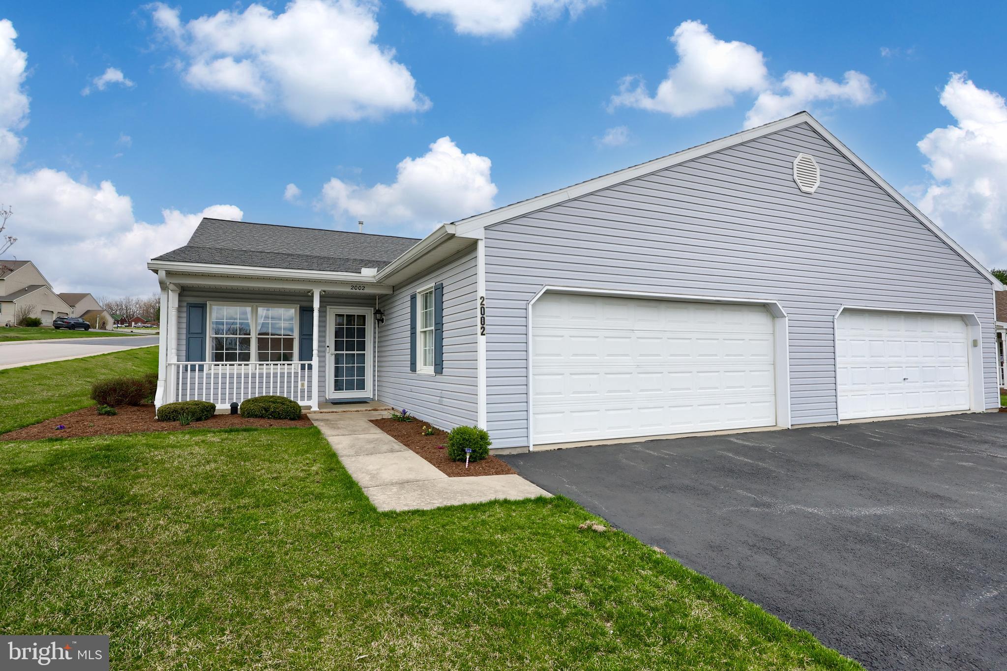 2002 Faversham Way York, PA 17402 - Photo 3 of 37 a front view of a house with a yard and porch