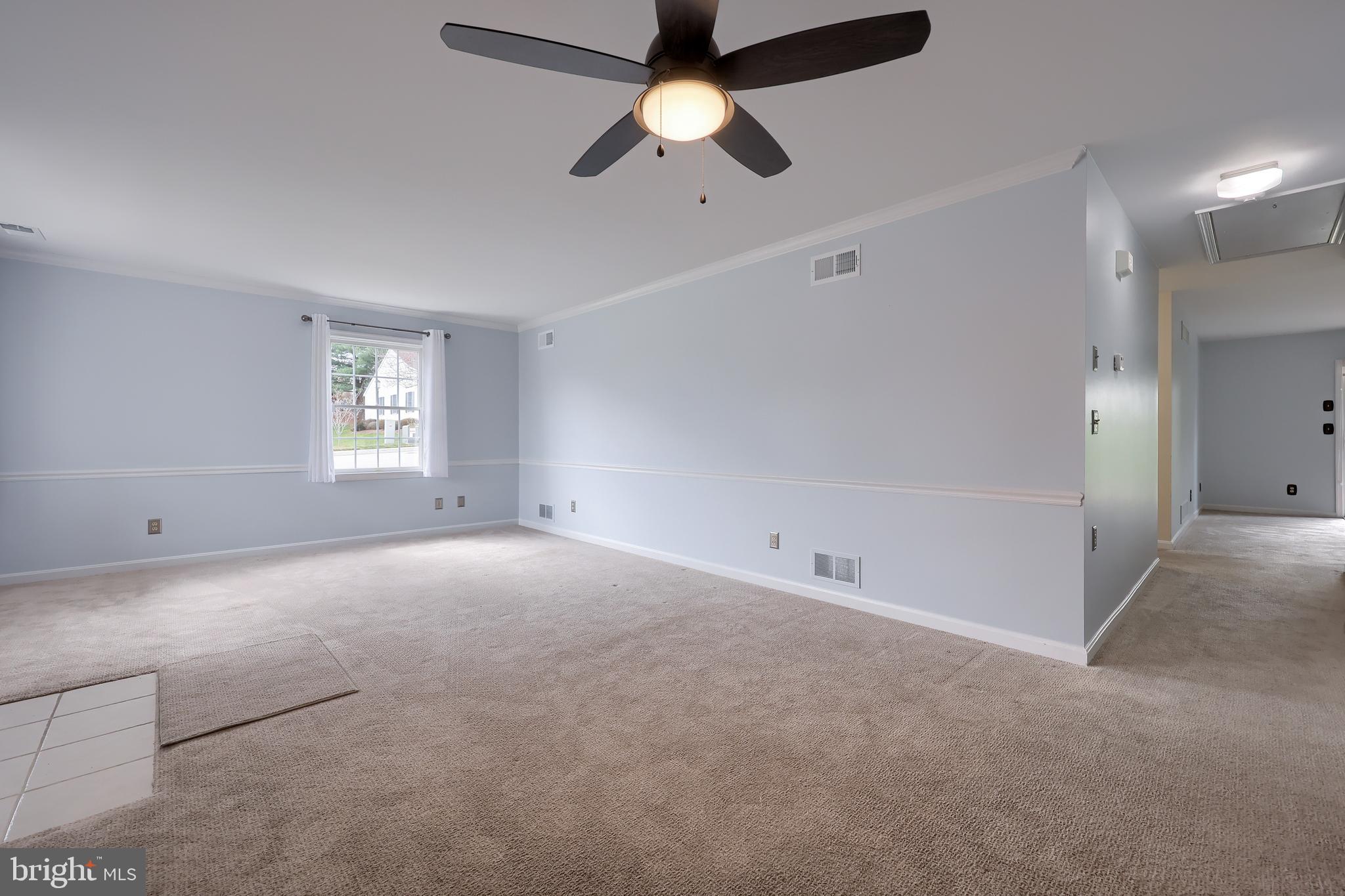 2002 Faversham Way York, PA 17402 - Photo 8 of 37 an empty room with chandelier fan and windows