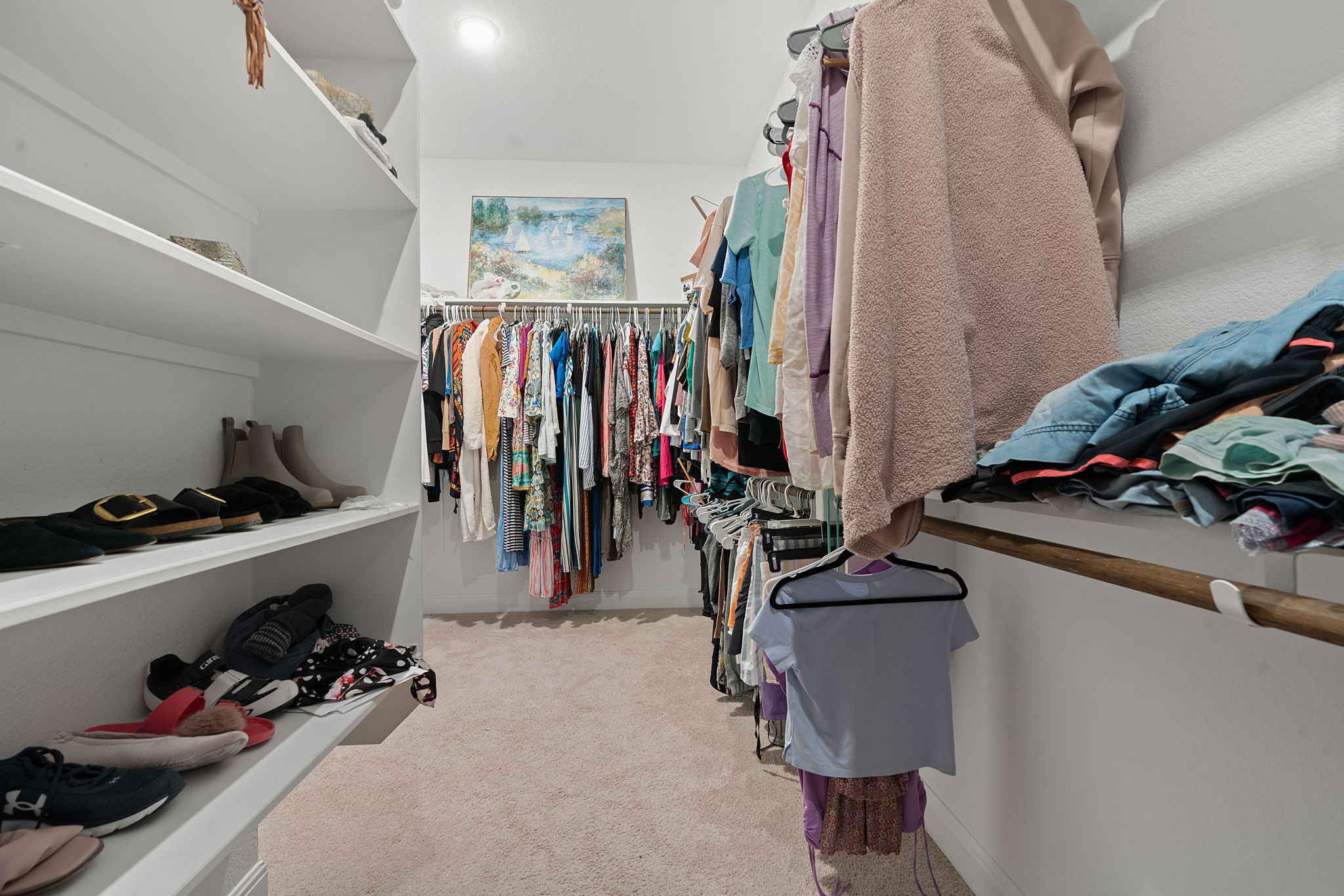 309 Pear Tree Lane Austin, TX 78737 - Photo 27 of 39 a view of walk in closet with clothes and shoes