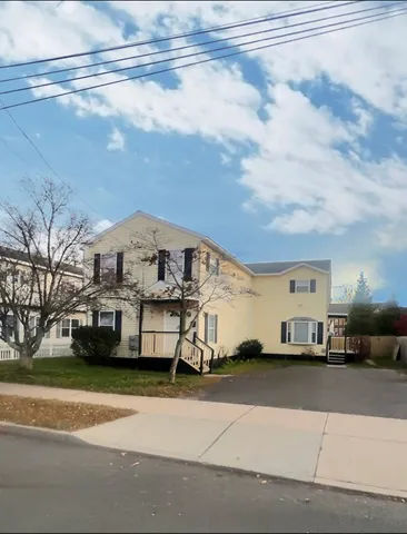 a view of a car parked in front of a house