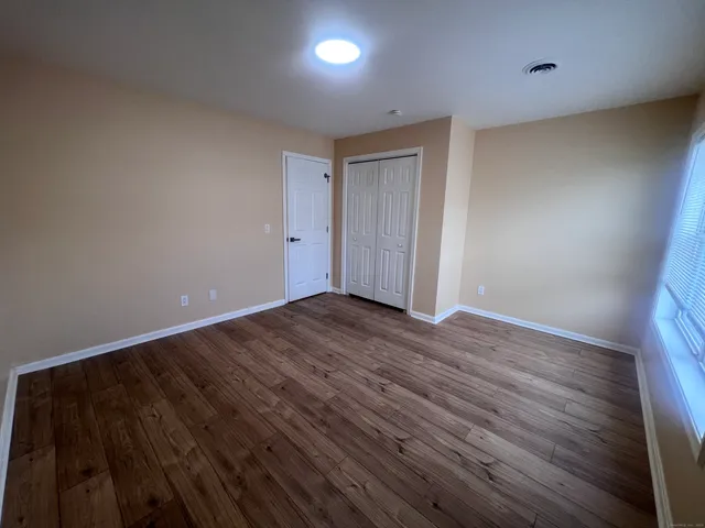 a view of room with wooden floor