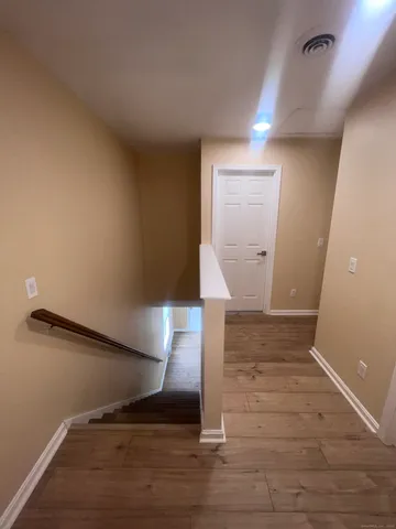 an empty room with a dresser and mirror