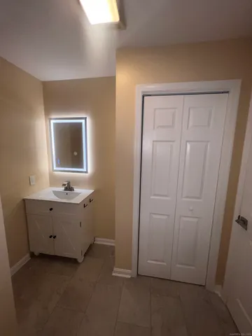 a white toilet sitting next to a bath tub