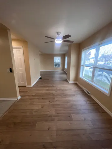 wooden floor in an empty room with a window