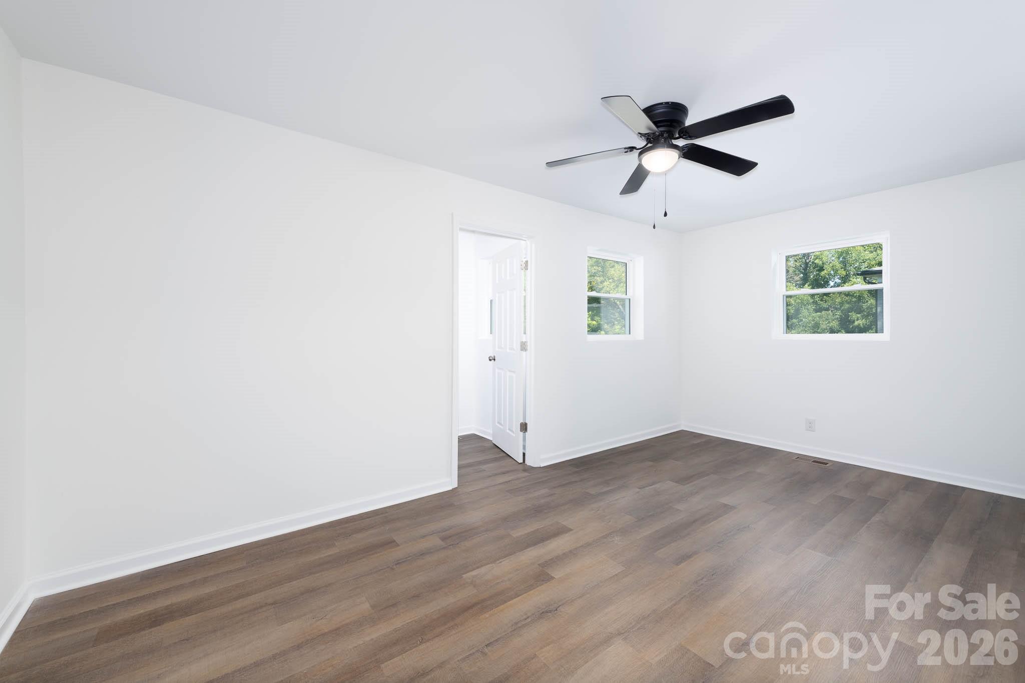 108 South Little Texas Road Kannapolis, NC 28083 - Photo 13 of 18 an empty room with wooden floor closet and windows