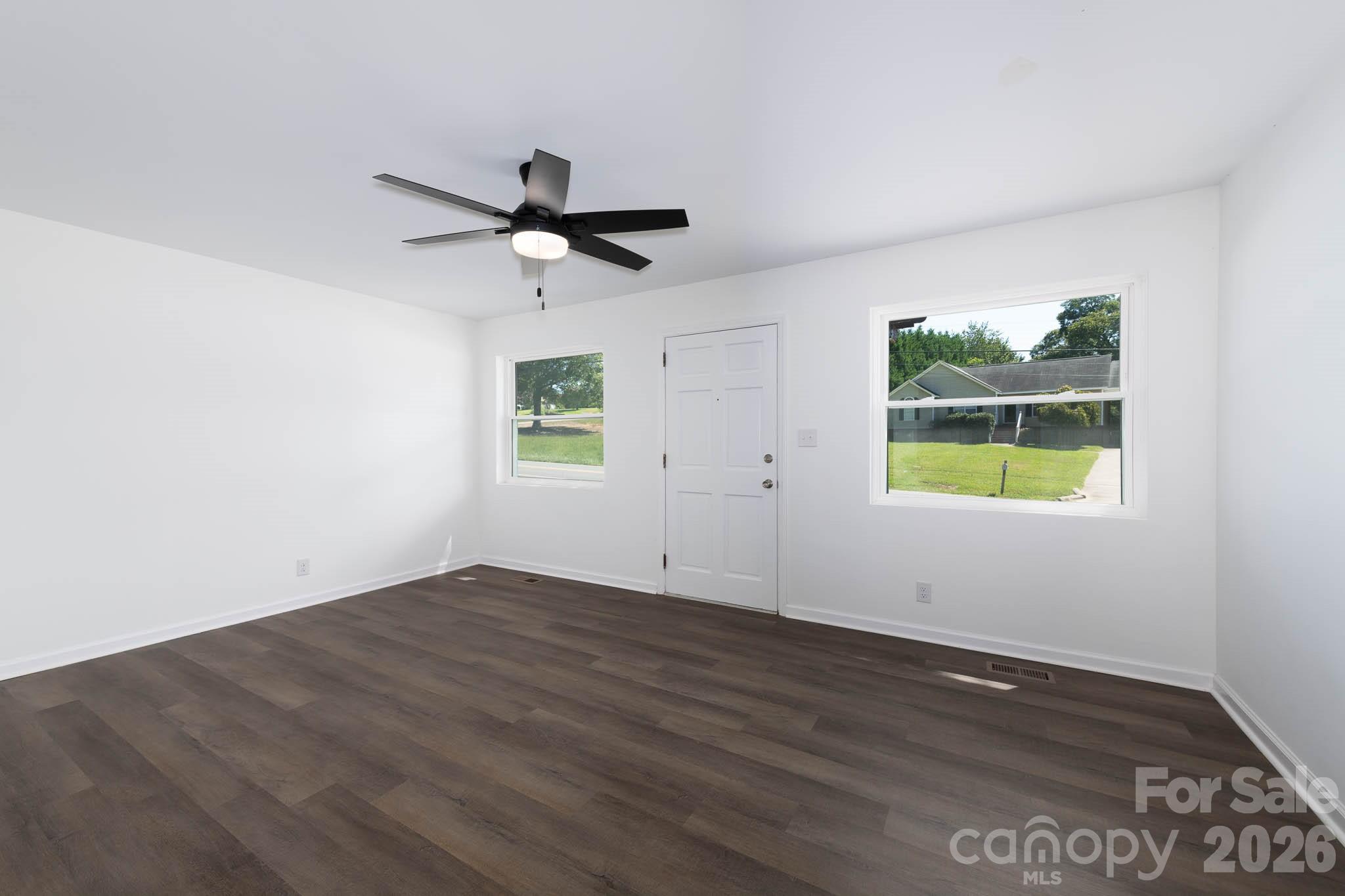108 South Little Texas Road Kannapolis, NC 28083 - Photo 3 of 18 an empty room with wooden floor and windows
