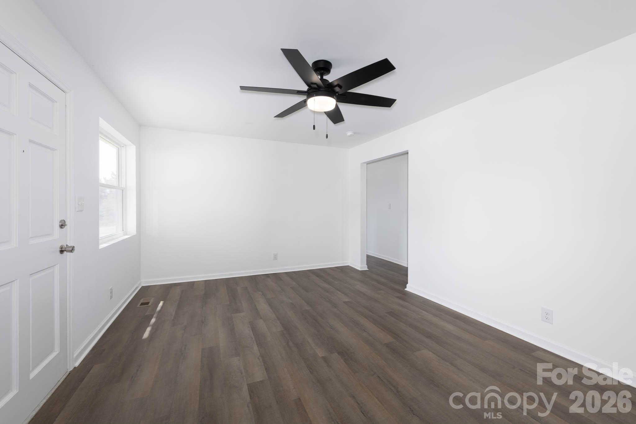 108 South Little Texas Road Kannapolis, NC 28083 - Photo 4 of 18 a view of a room with wooden floor and a ceiling fan