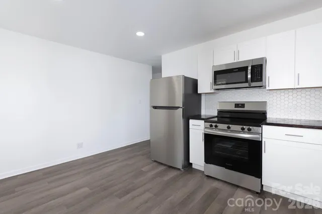 a kitchen with a refrigerator stove and microwave