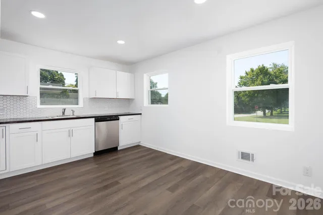 a kitchen with a sink cabinets and window