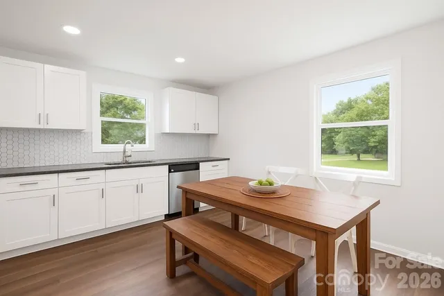 a kitchen with a table and chairs in it