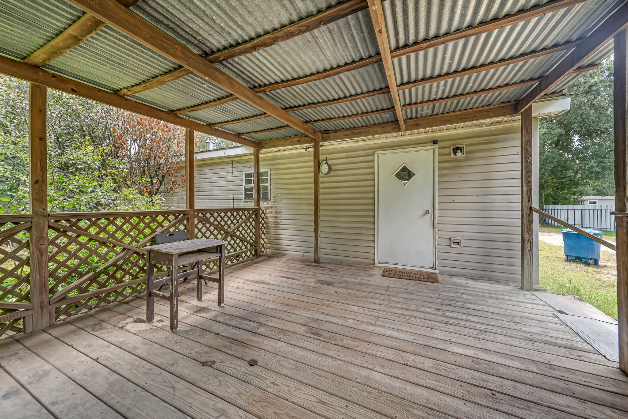 25979 Shade Tree Lane Splendora, TX 77372 - Photo 10 of 22 Designed for year-round enjoyment, the covered back porch offers a comfortable outdoor living space with plenty of room to relax and enjoy the country setting.