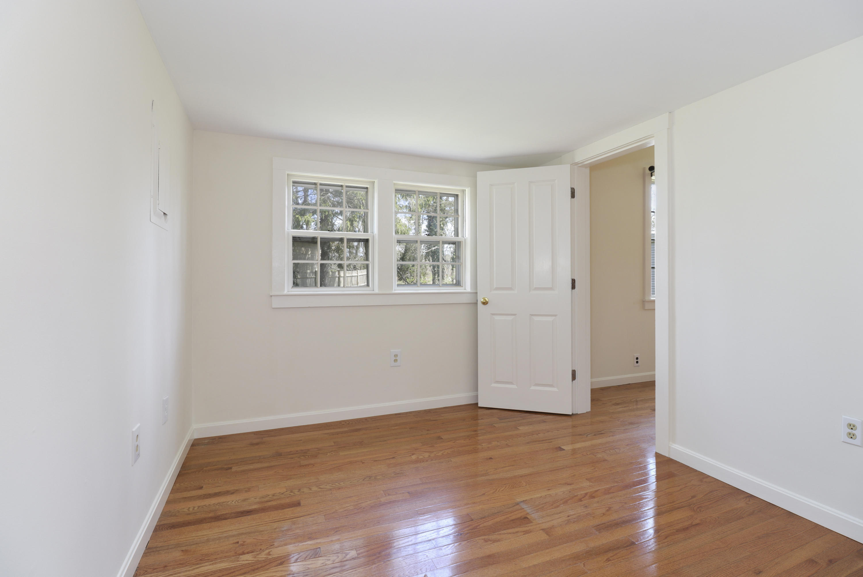1245 A County Road Cataumet, MA 02534 - Photo 17 of 23 an empty room with wooden floor and windows