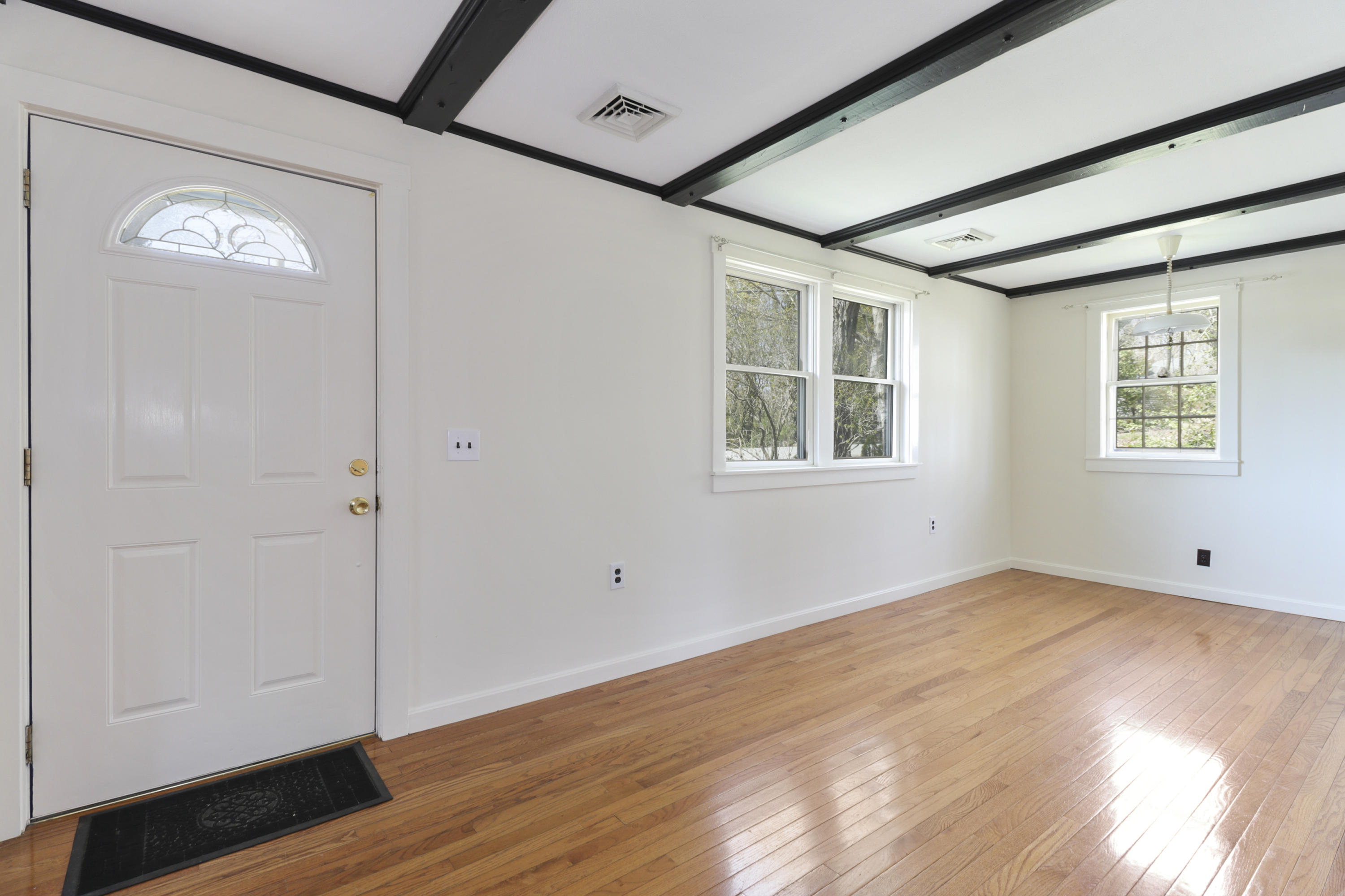 1245 A County Road Cataumet, MA 02534 - Photo 4 of 23 an empty room with wooden floor and windows