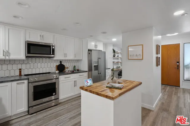 a kitchen with a sink stove and refrigerator