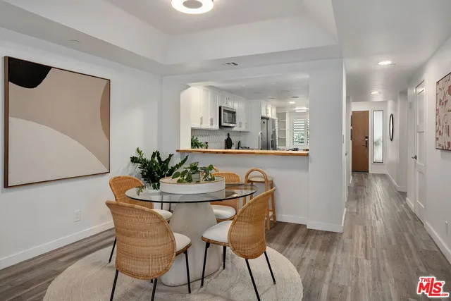 a dining room with furniture and wooden floor