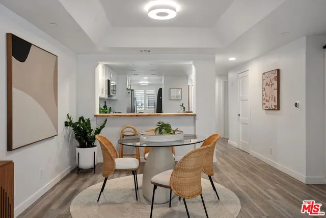 a view of a dining room with furniture and a potted plant