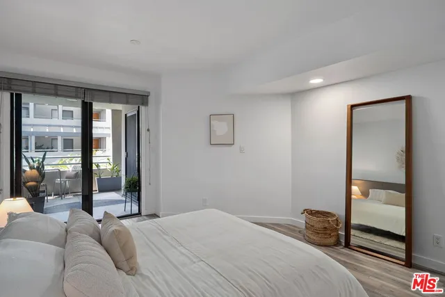 a bedroom with a large bed and a large window