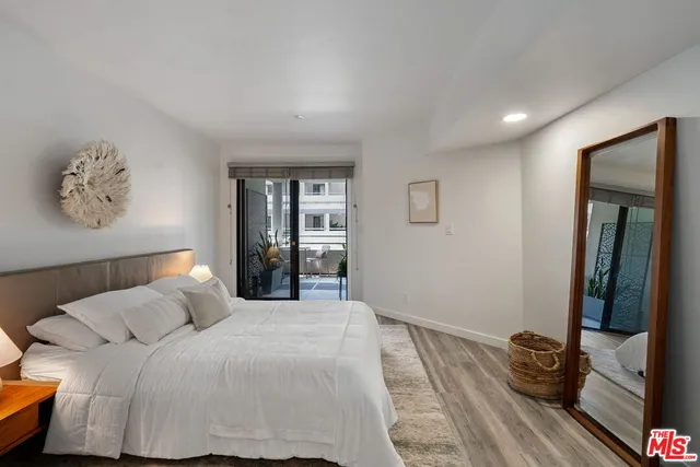 a bedroom with a bed and glass walk in closet