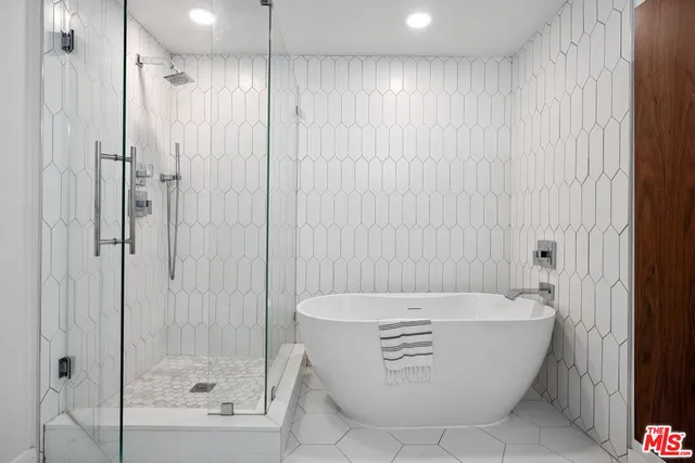 a bathroom with a bathtub and shower