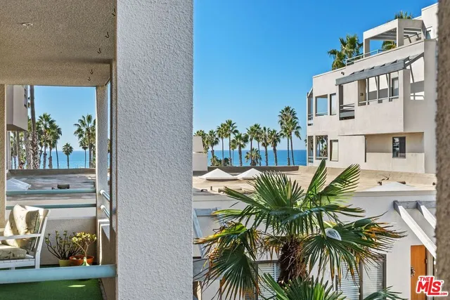 a bedroom with a bed and a potted plant