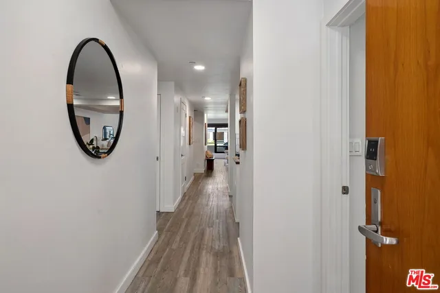 a view of a hallway with wooden floor