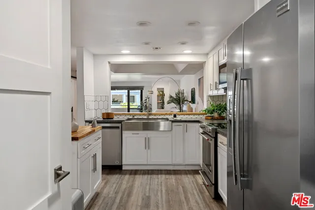 a kitchen with counter top space and stainless steel appliances