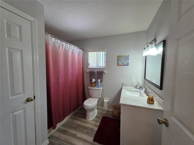 a front view of a house with a garden and yard