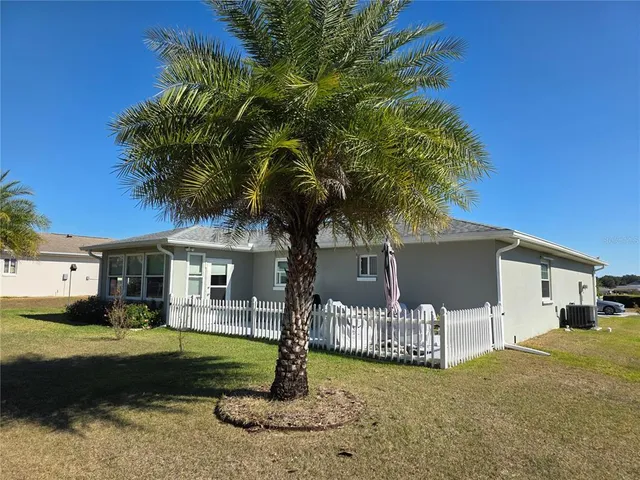 an aerial view of a residential houses with outdoor space and street view