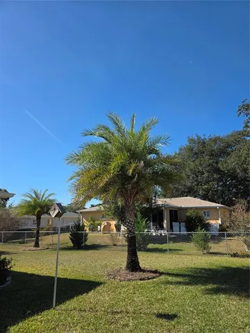 an aerial view of a house with swimming pool and patio