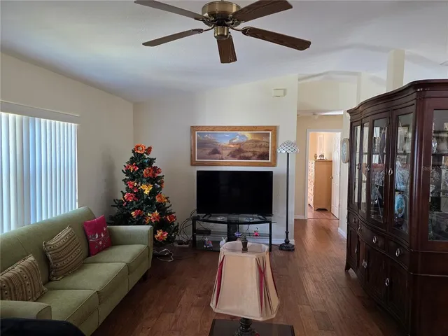 a dining room with furniture a chandelier and window