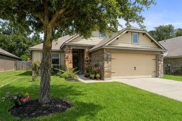 a front view of a house with a yard and garage