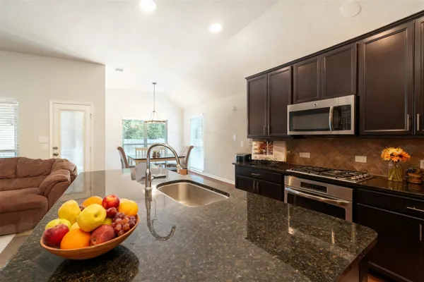 a kitchen with a stove a microwave and sink