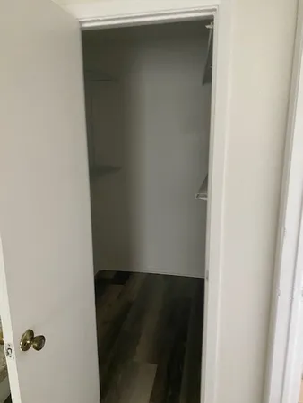 a bathroom with a granite countertop toilet a sink and a mirror