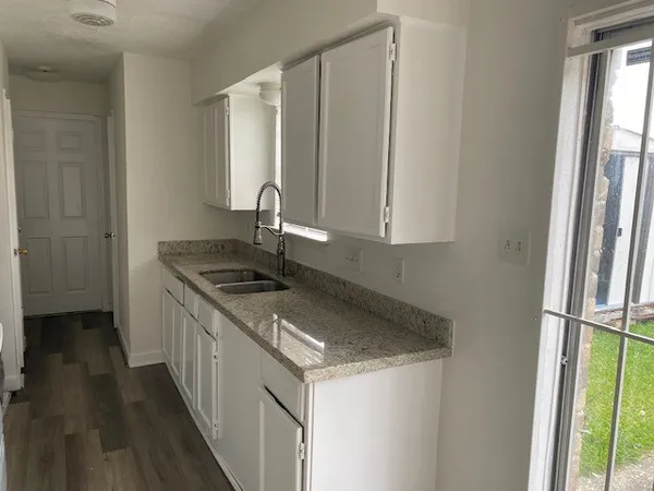 a kitchen with a sink stove and cabinets