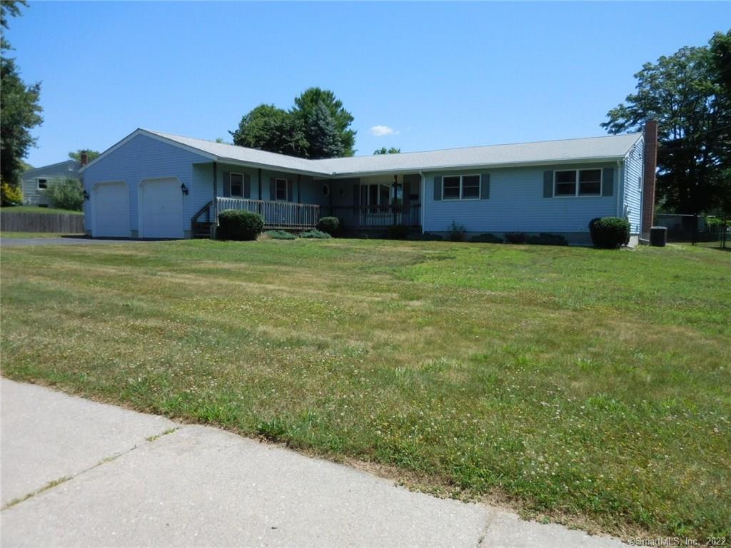a front view of house with yard and green space