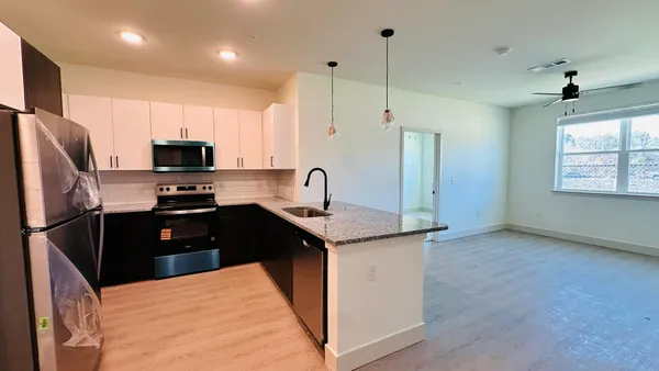 a view of a hallway with a kitchen