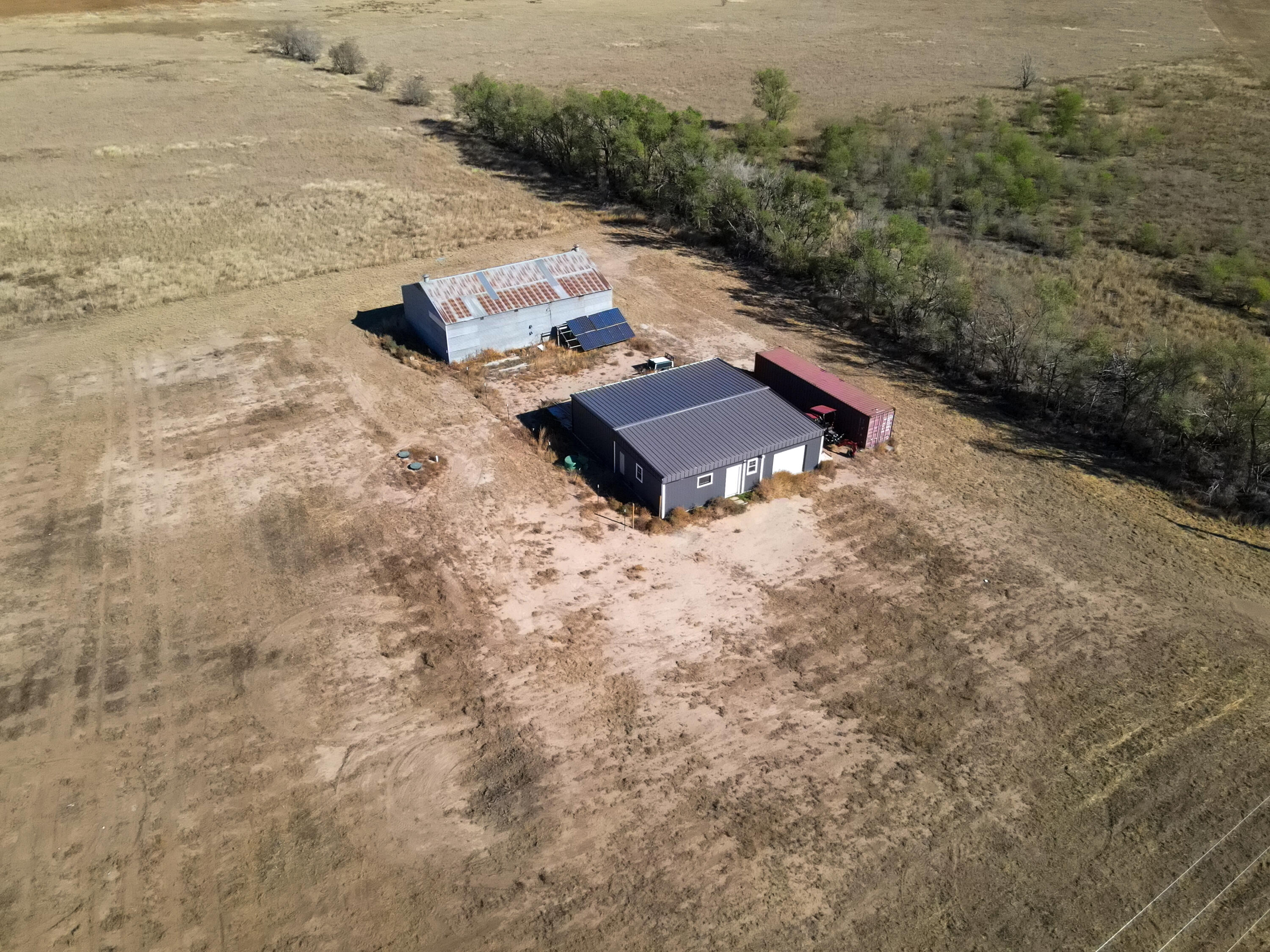 an aerial view of a house with yard and mountain view in back
